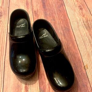 Dansko Black Slippers with Smooth Polished Surface and Durable Construction